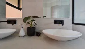 A wall-plate mixer on a bathroom sink. 